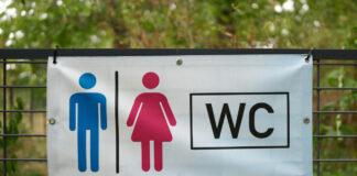 Hinweisschild weist auf nahe Toilette hin.