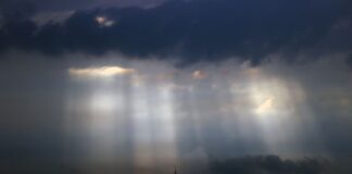 Sonnenstrahlen dringen durch Wolkenlücken.