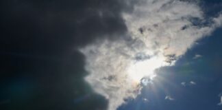 Die Sonne kommt hinter Regenwolken hervor.