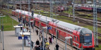 Der Regionalzug RE4 der Deutschen Bahn wartet an einem Bahnhof und fährt anschließend in Richtung Jüterbog.