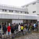 Teilnehmer einer Demonstration von Fridays for Israel stehen vor der FU-Berlin.