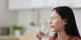 Eine junge Frau trinkt ein Glas Wasser. Foto: IMAGO / Panthermedia