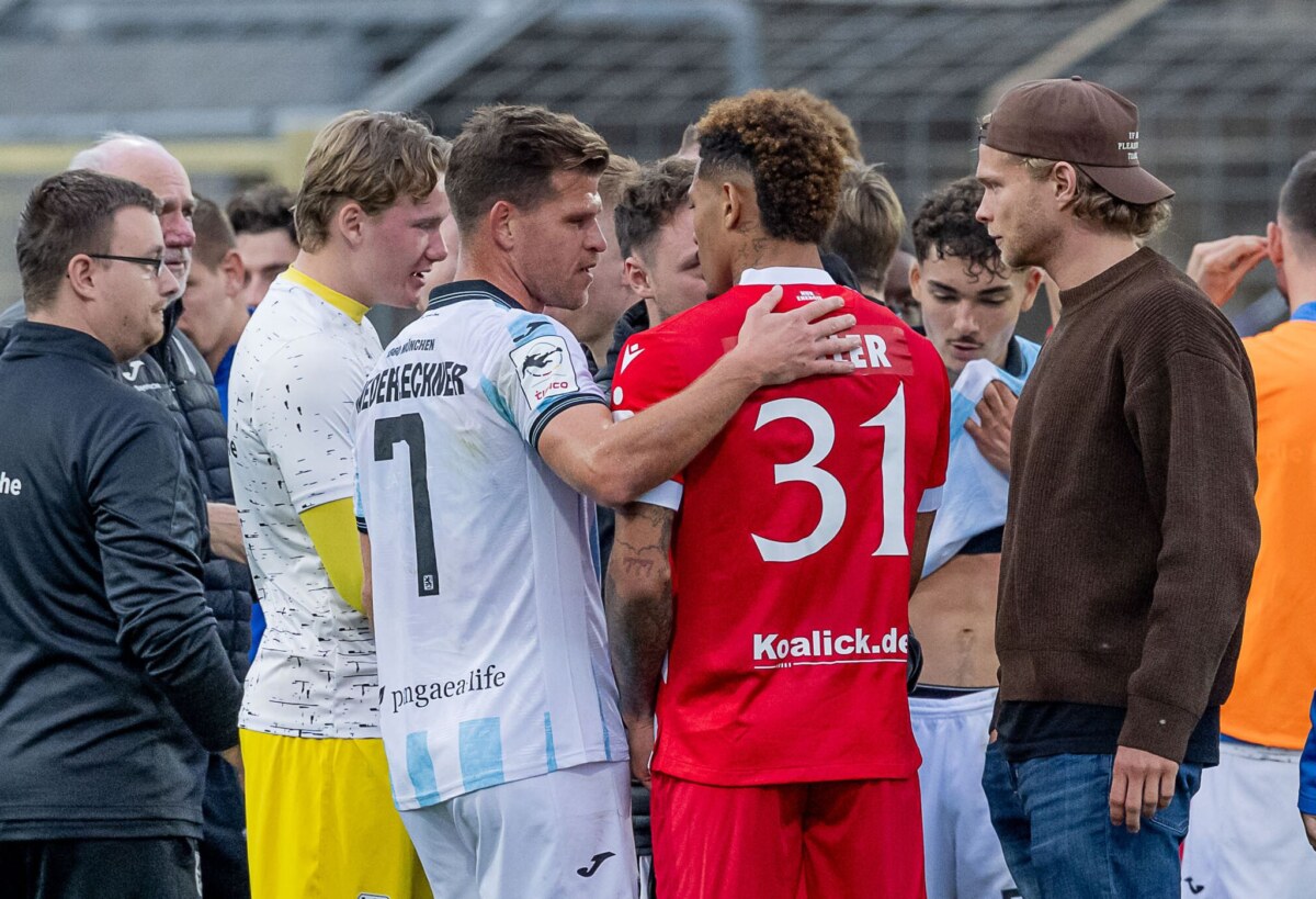 TSV 1860 München - FC Energie Cottbus Florian Niederlechner (TSV 1860 München) spricht nach dem Rassismus-Vorfall aufmunternd mit Justin Butler (FC Energie Cottbus).