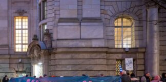 Nach Verurteilung zu Neukölln-Komplex: Täter in Haft Demonstranten stehen während des Berufungsprozesses zu rechtsextremen Straftaten vor dem Berliner Landgericht. (Archivbild)